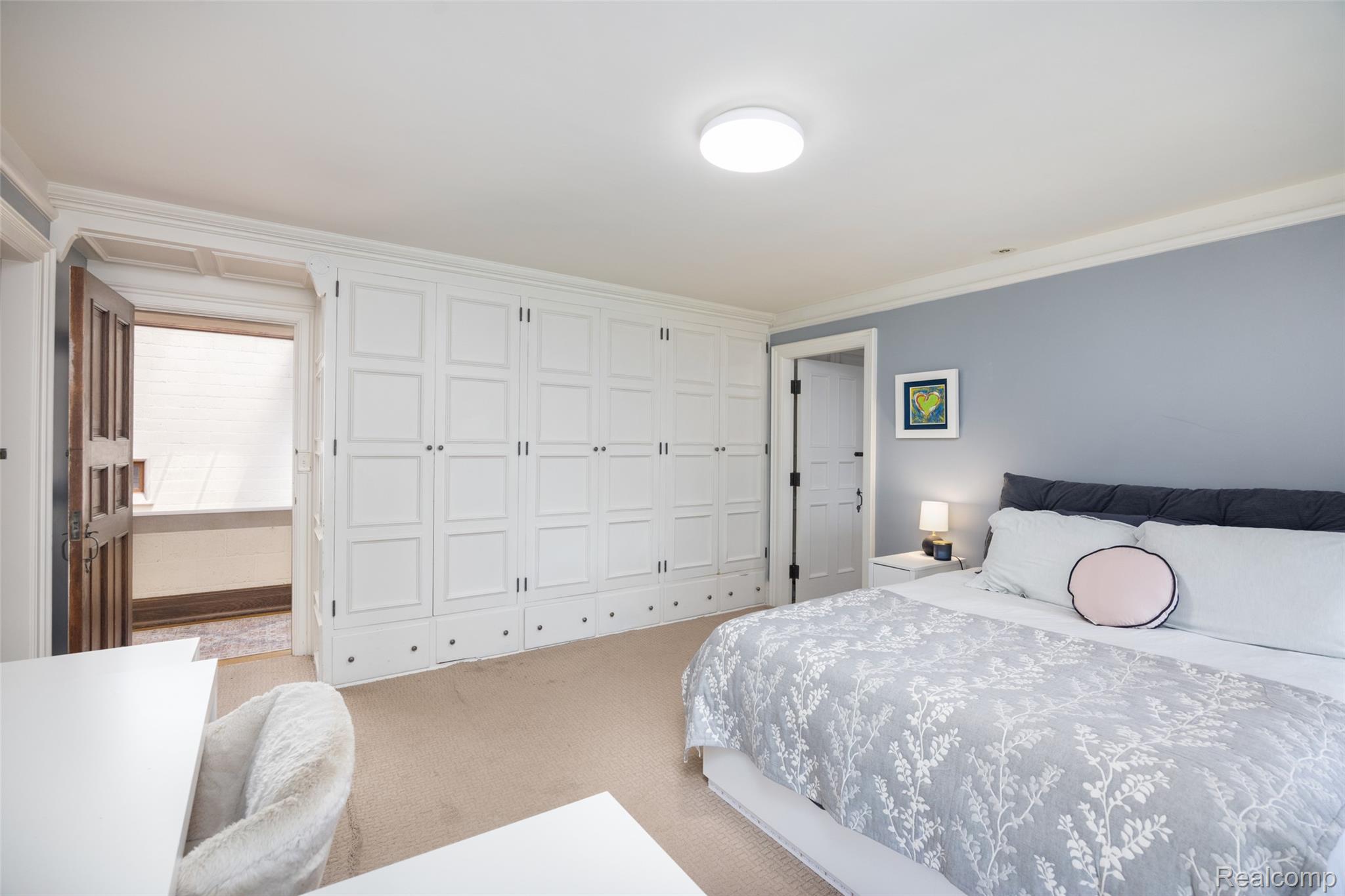 189 Cloverly Road Grosse Pointe, MI 48236 - Photo 49 of 93 An entire wall of custom built-in wardrobes provides exceptional storage while preserving the clean architectural lines of the room.