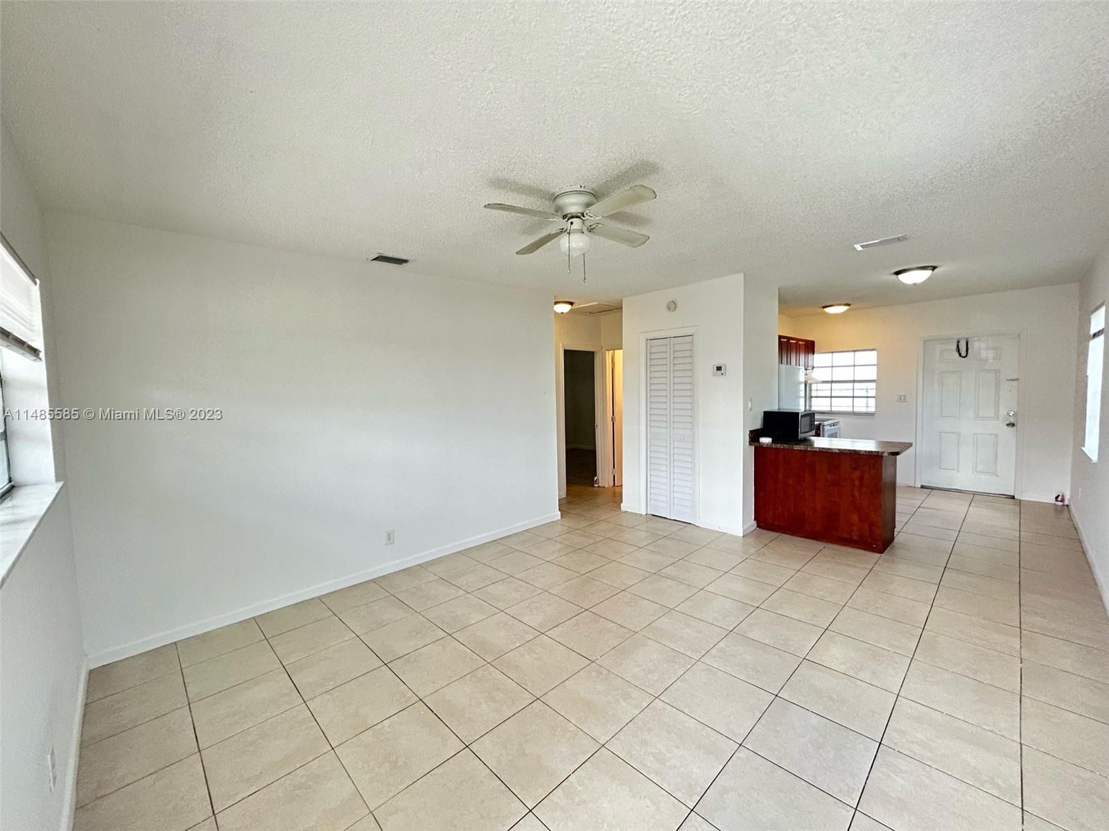 990 Phippen Waiters Road, Unit 1 Dania Beach, FL 33004 - Photo 3 of 8 a view of a kitchen with a sink and a mirror