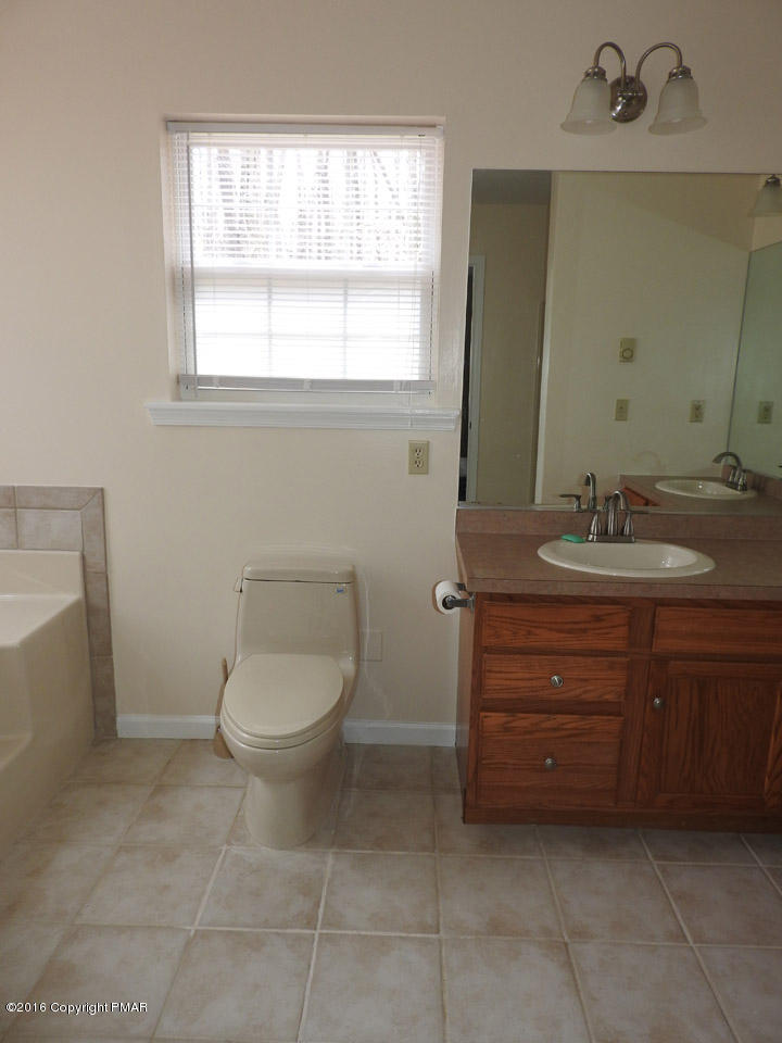 137 Lidio Road Blakeslee, PA 18610 - Photo 14 of 28 a bathroom with a toilet a sink and mirror