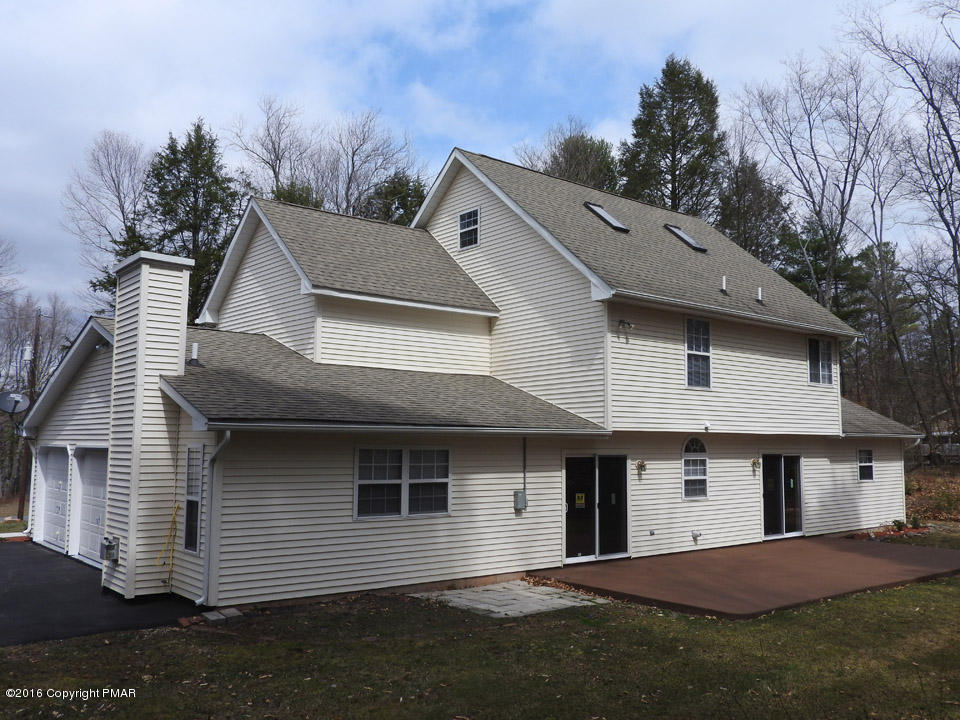 137 Lidio Road Blakeslee, PA 18610 - Photo 26 of 28 a front view of a house with a yard and garage
