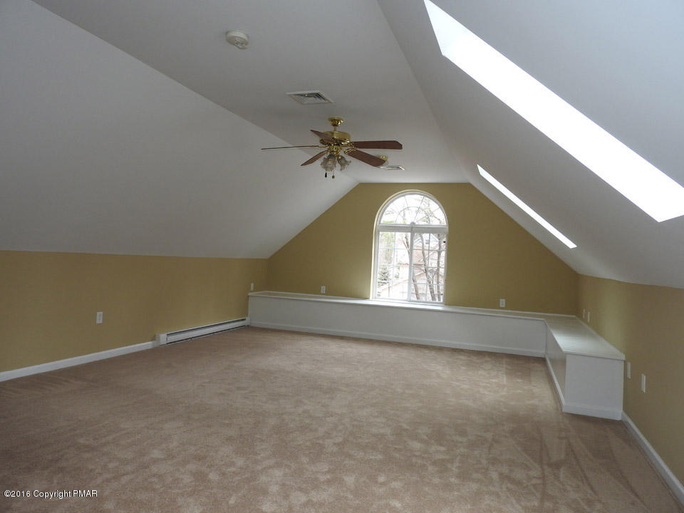 137 Lidio Road Blakeslee, PA 18610 - Photo 5 of 28 an empty room with a window and a ceiling fan