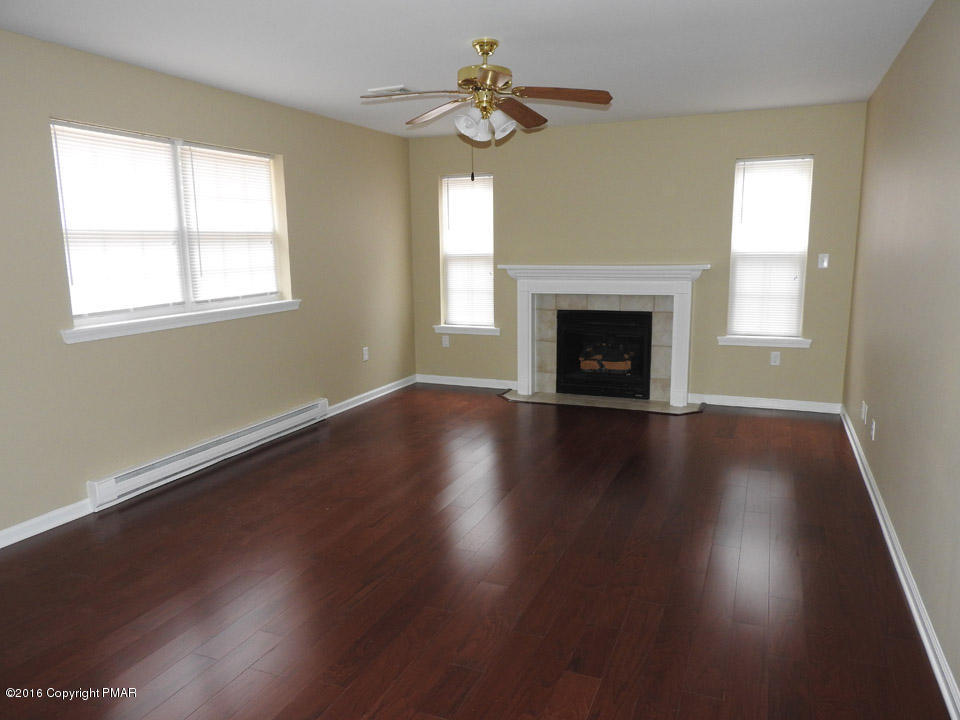 137 Lidio Road Blakeslee, PA 18610 - Photo 6 of 28 a view of a room with wooden floor fireplace and windows