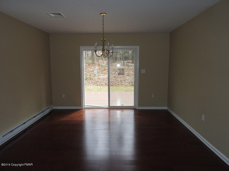 137 Lidio Road Blakeslee, PA 18610 - Photo 9 of 28 a view of an empty room with wooden floor and a window