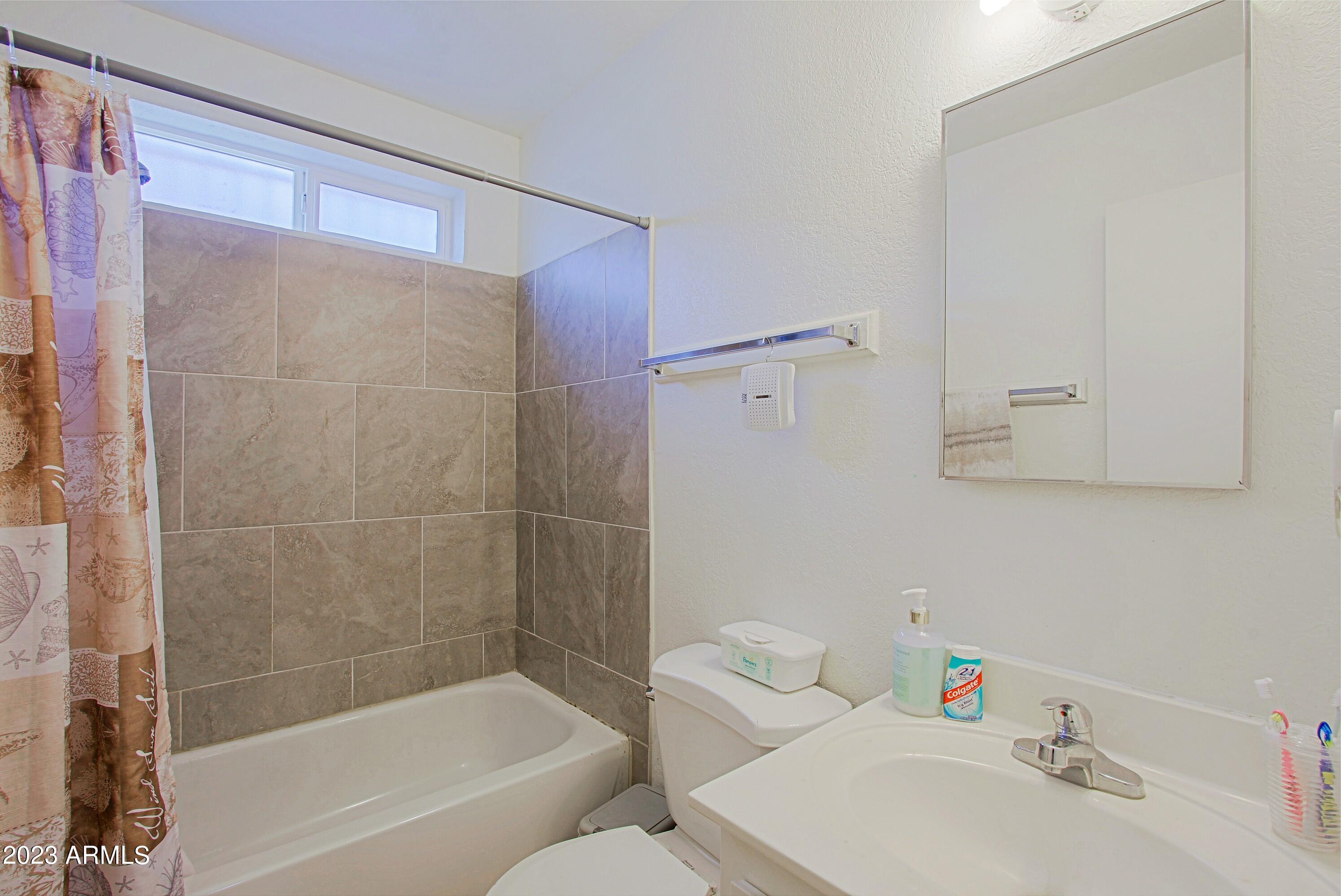 1734 West Fremont Rd. Phoenix, AZ 85041 - Photo 24 of 33 Guest bathroom with tile surround