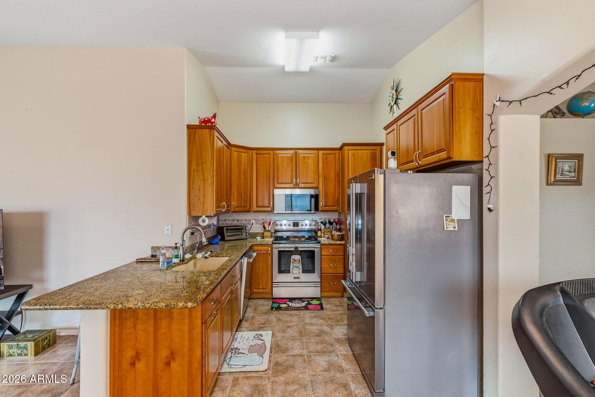 15843 West Washington Street Goodyear, AZ 85338 - Photo 14 of 39 a kitchen with a refrigerator a stove and a sink