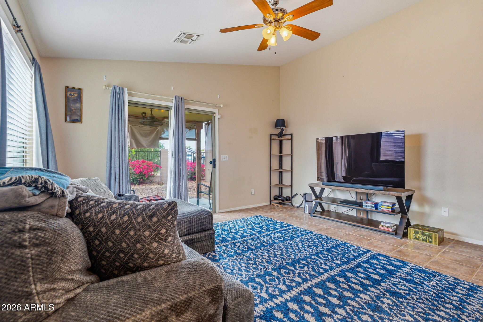 15843 West Washington Street Goodyear, AZ 85338 - Photo 15 of 39 a living room with furniture and a flat screen tv