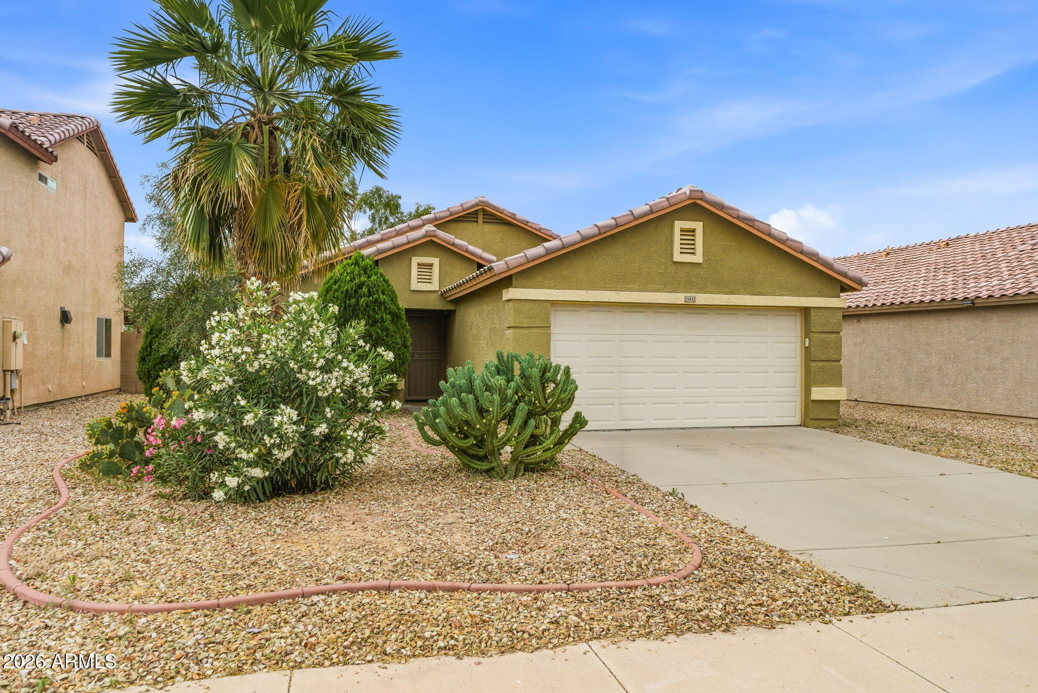 15843 West Washington Street Goodyear, AZ 85338 - Photo 2 of 39 a front view of a house with a garden