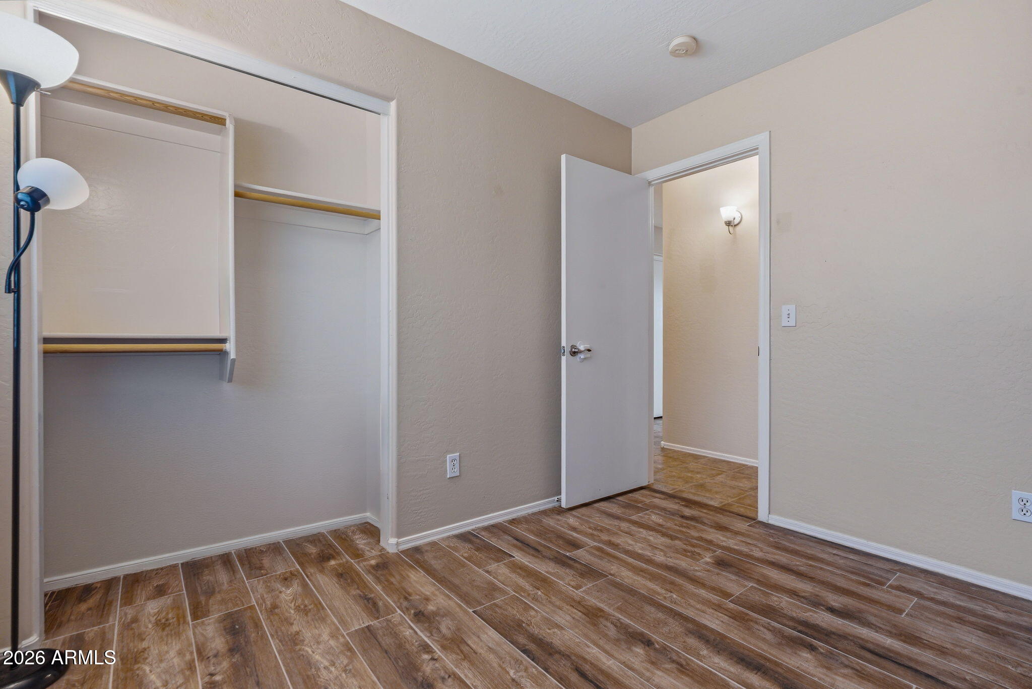 15843 West Washington Street Goodyear, AZ 85338 - Photo 25 of 39 a view of an empty room with wooden floor and a window