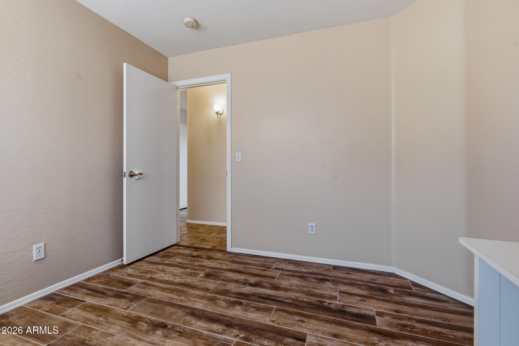 15843 West Washington Street Goodyear, AZ 85338 - Photo 26 of 39 a view of a room with wooden floor and closet