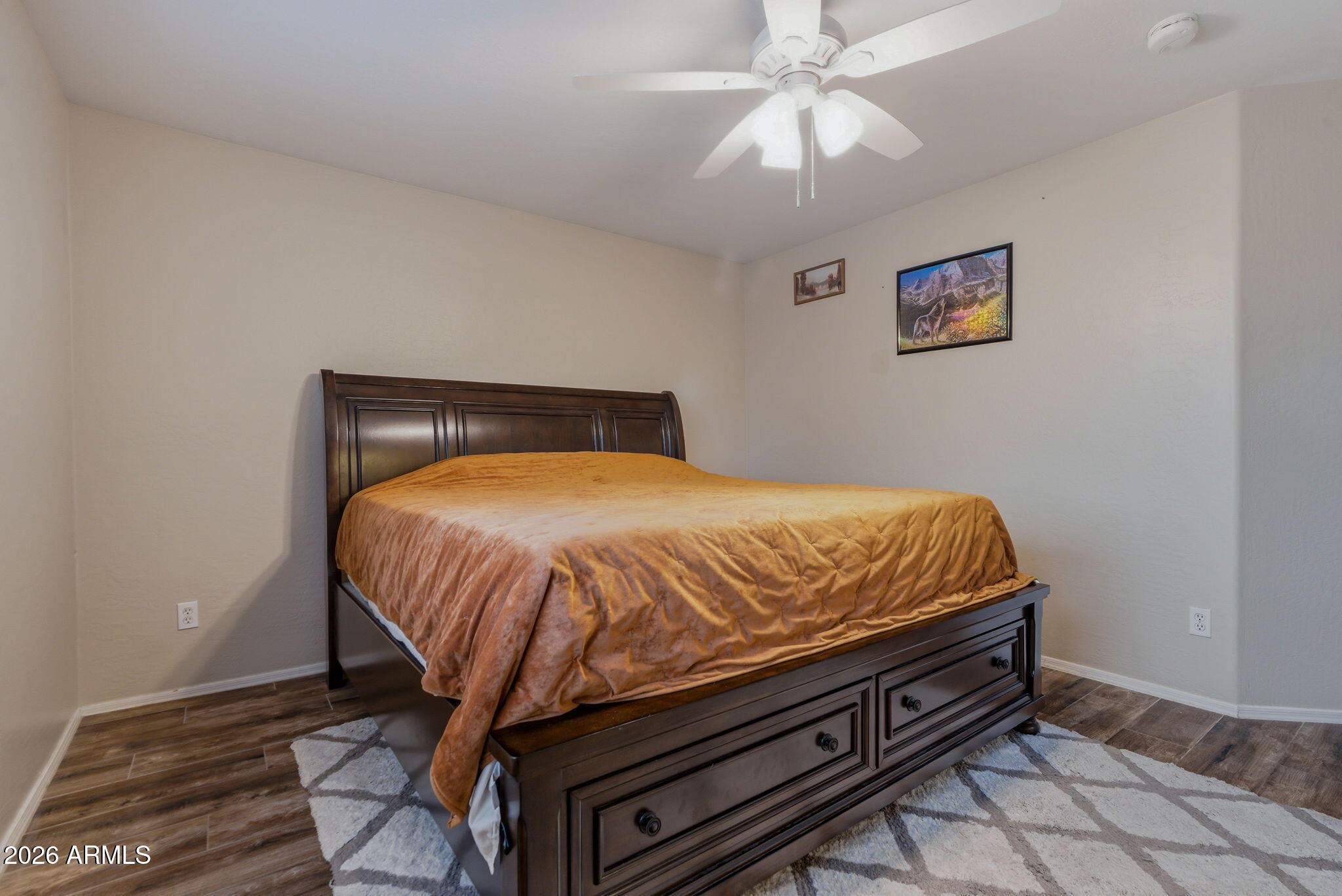 15843 West Washington Street Goodyear, AZ 85338 - Photo 28 of 39 a bed sitting in a bedroom next to a lamp