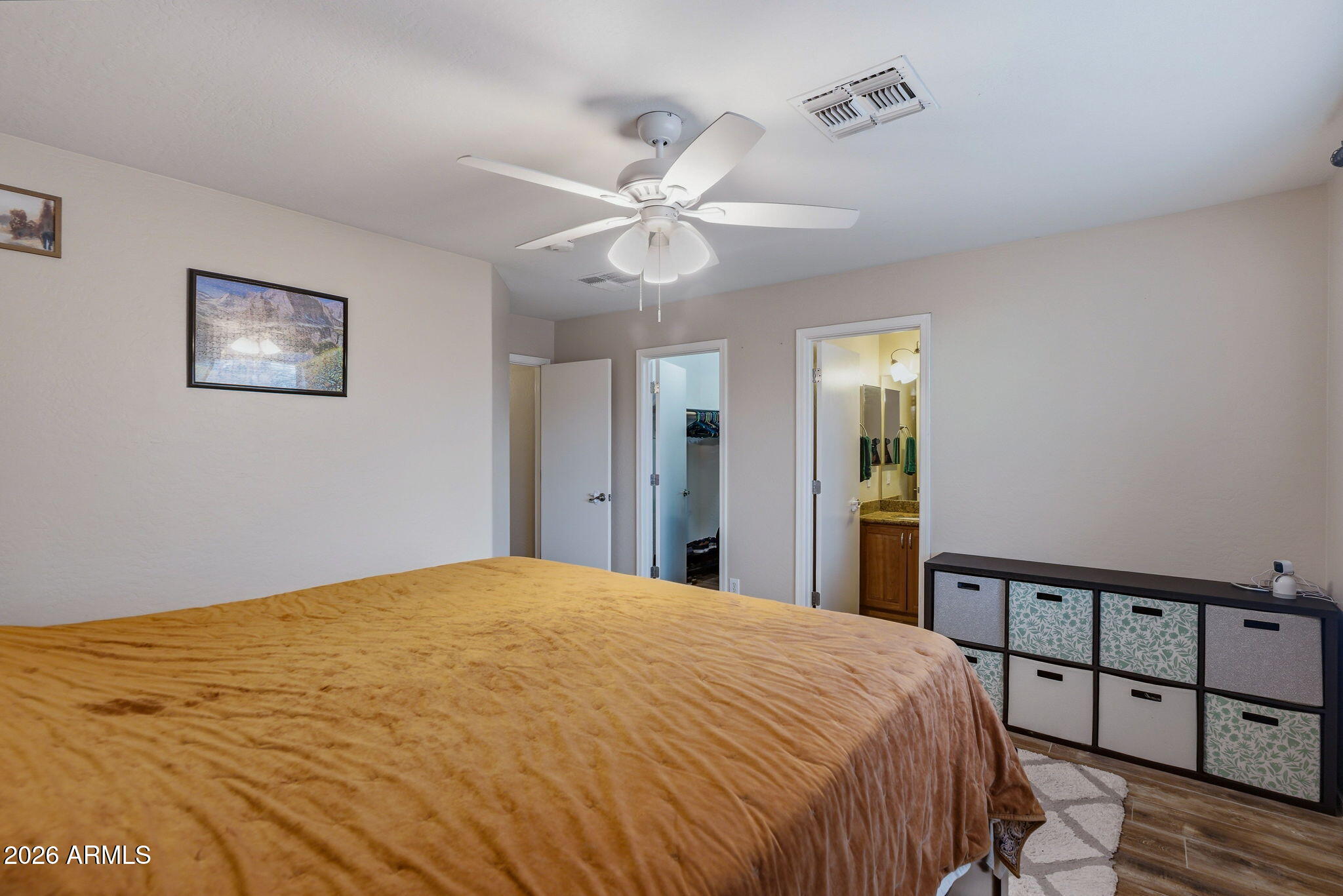 15843 West Washington Street Goodyear, AZ 85338 - Photo 29 of 39 a bedroom with a large bed and a chandelier