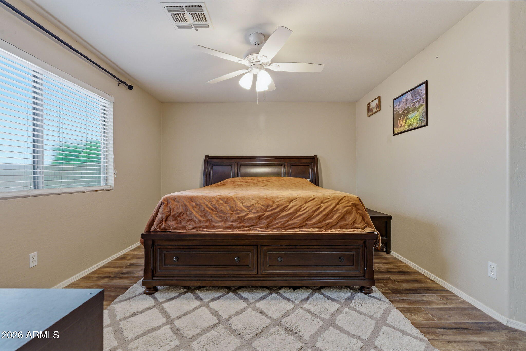 15843 West Washington Street Goodyear, AZ 85338 - Photo 30 of 39 a bed sitting in a bedroom next to a window