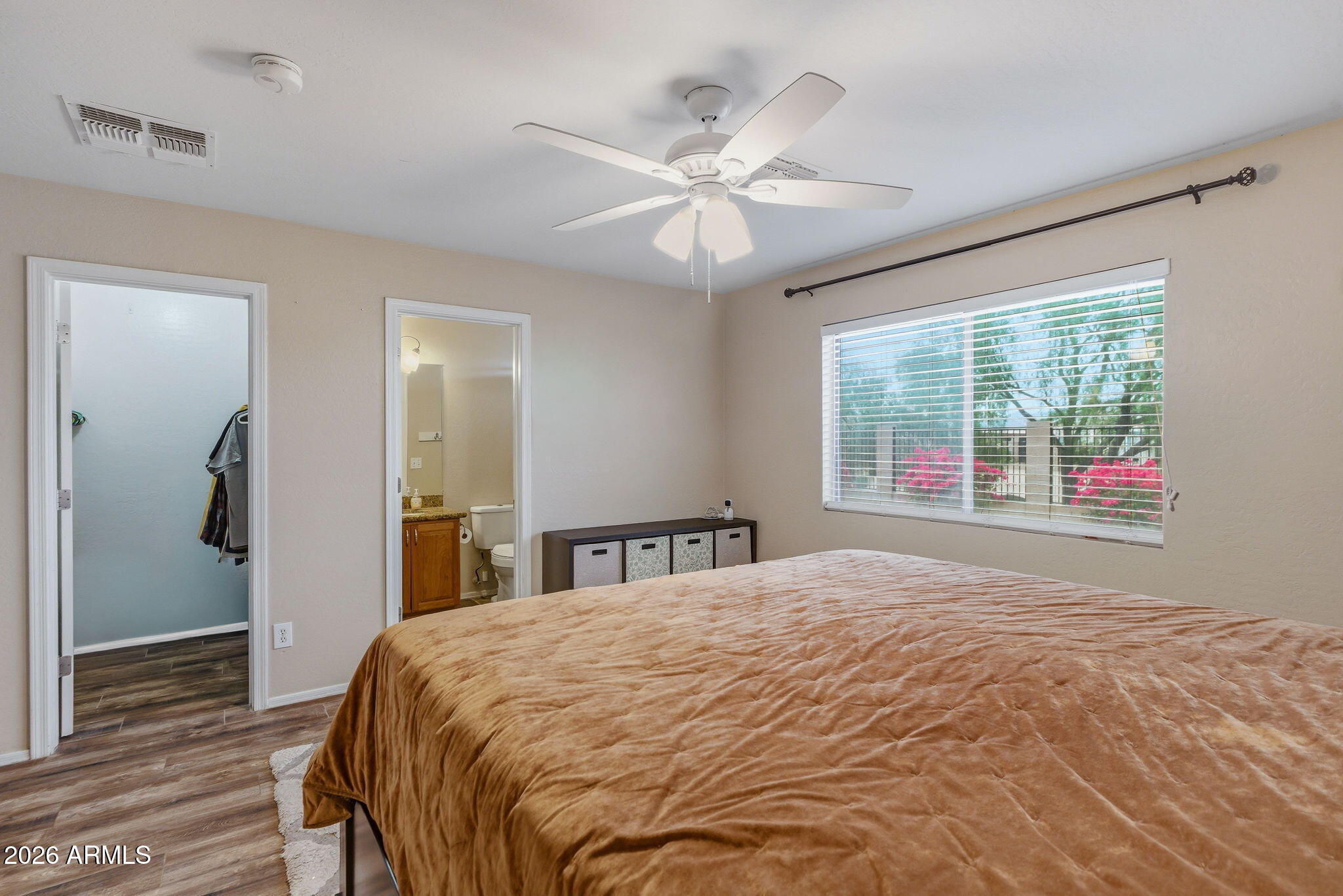 15843 West Washington Street Goodyear, AZ 85338 - Photo 31 of 39 a bedroom with a large bed and a chandelier
