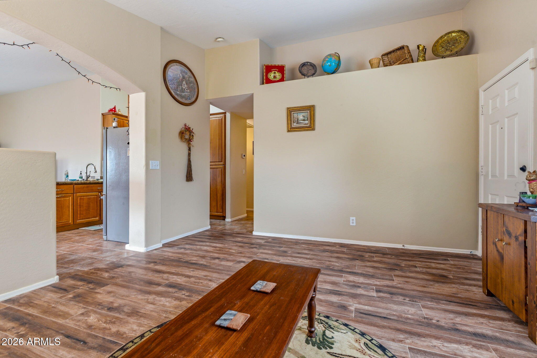 15843 West Washington Street Goodyear, AZ 85338 - Photo 5 of 39 a view of a hallway with wooden floor