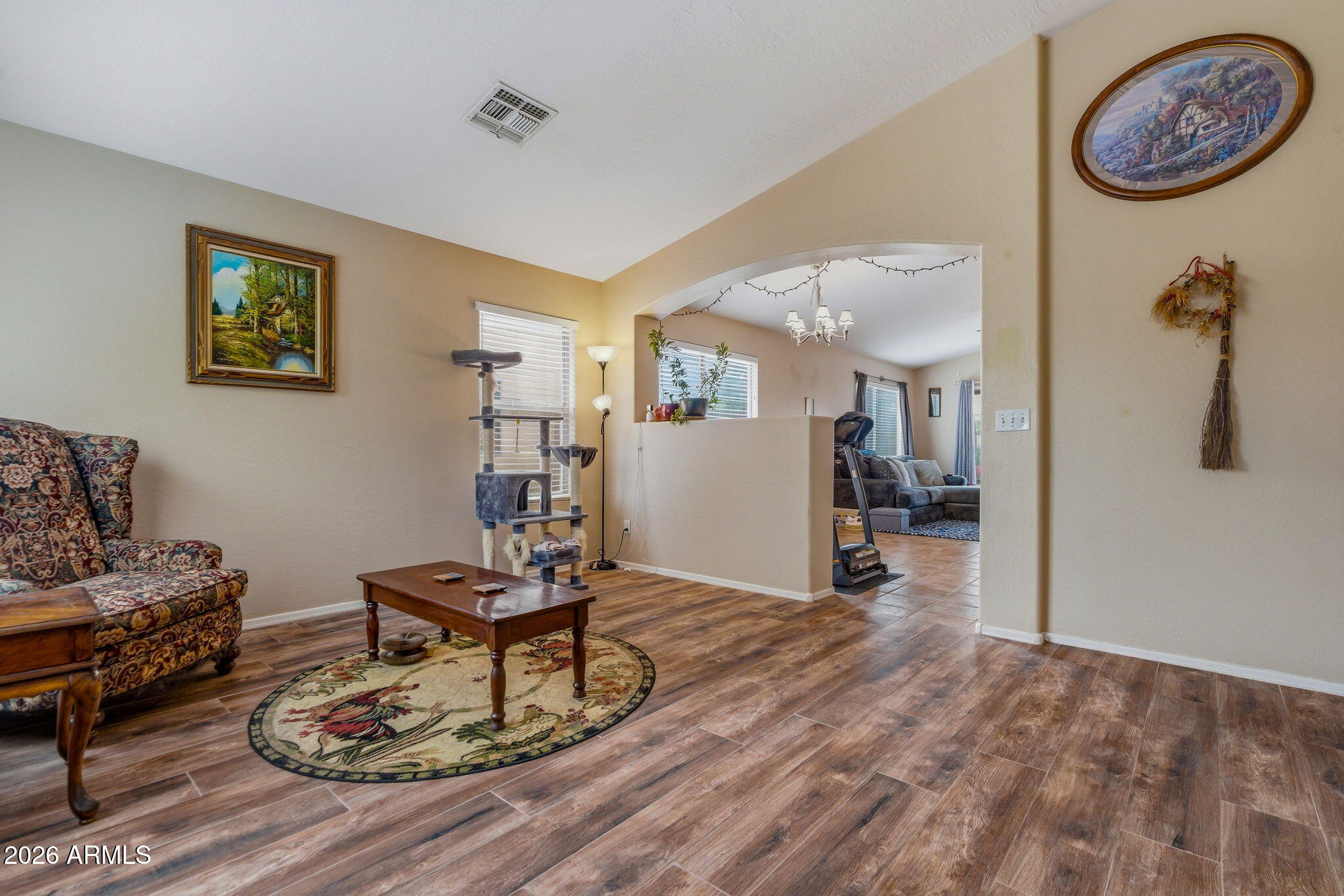 15843 West Washington Street Goodyear, AZ 85338 - Photo 7 of 39 a living room with furniture and a wooden floor