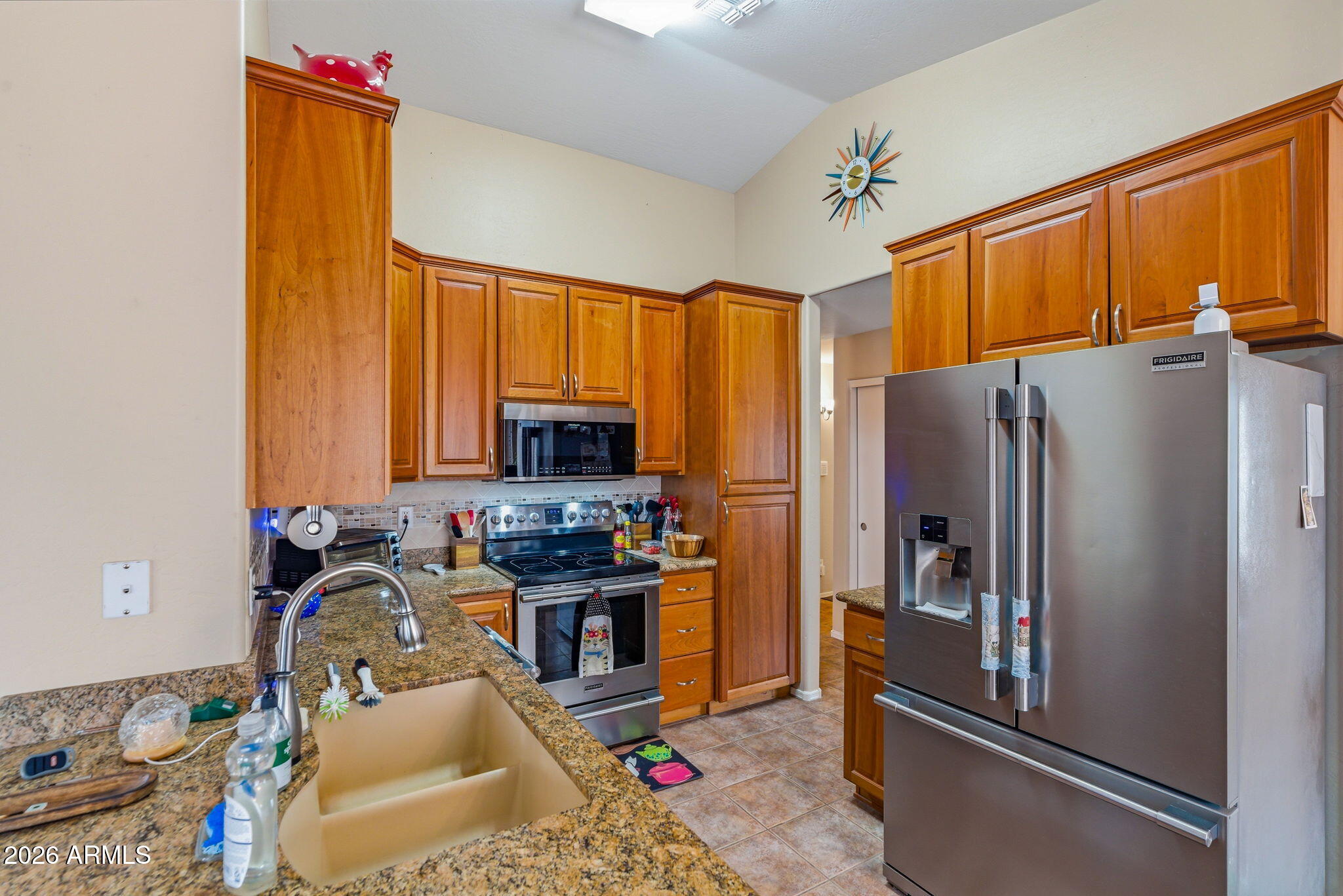 15843 West Washington Street Goodyear, AZ 85338 - Photo 8 of 39 a kitchen with stainless steel appliances granite countertop a refrigerator stove and sink