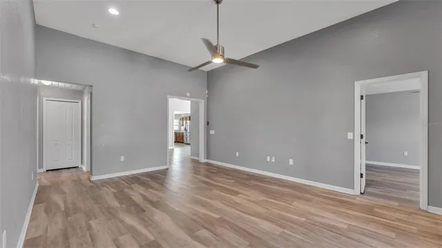 a view of an empty room with window wooden floor and closet