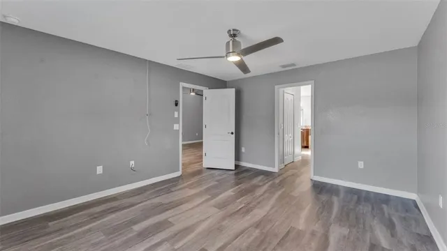 wooden floor in an empty room with a window