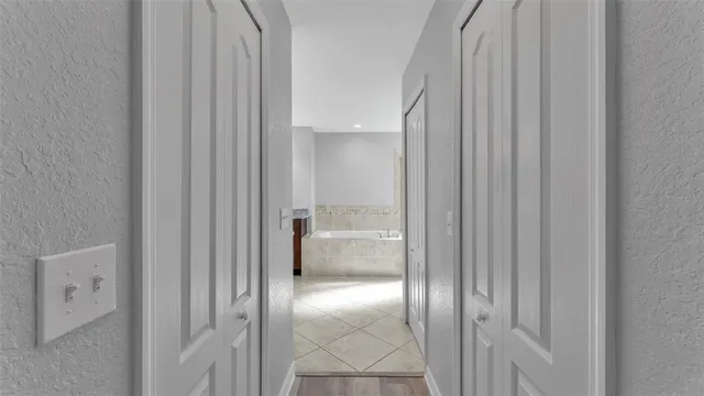 a bathroom with a granite countertop bathtub a sink and a large mirror