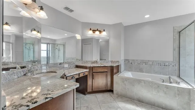 a bathroom with a tub shower and toilet