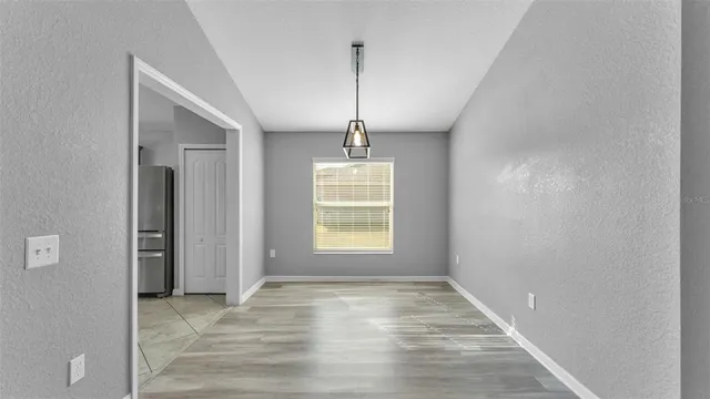 a view of a room with wooden floor and windows