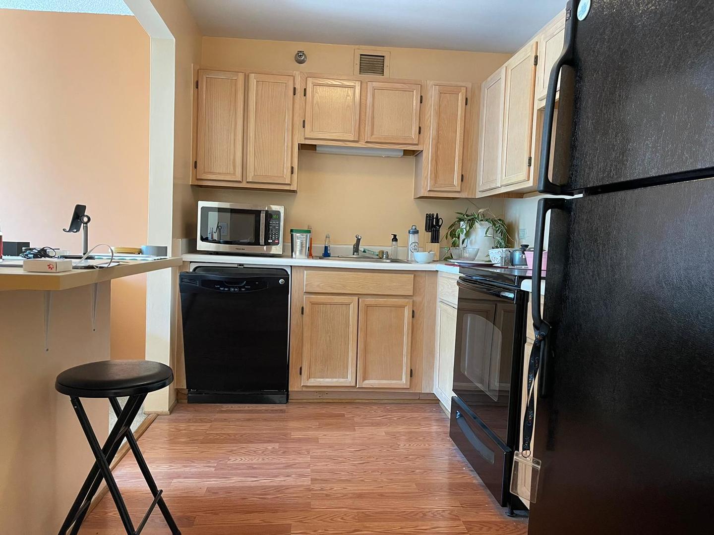 200 North Dearborn Street, Unit 1901 Chicago, IL 60601 - Photo 2 of 24 a kitchen with stainless steel appliances granite countertop a refrigerator a stove a sink dishwasher and white cabinets with wooden floor