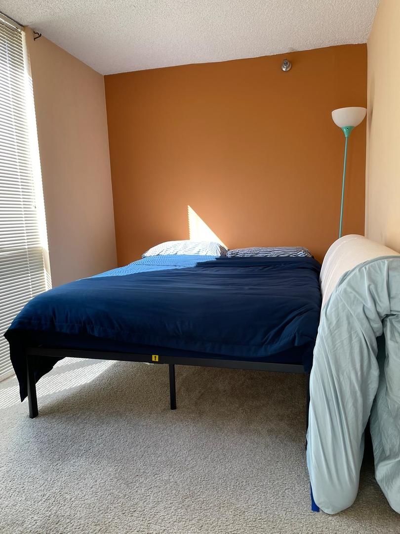 200 North Dearborn Street, Unit 1901 Chicago, IL 60601 - Photo 14 of 24 a bed sitting in a bedroom next to a window