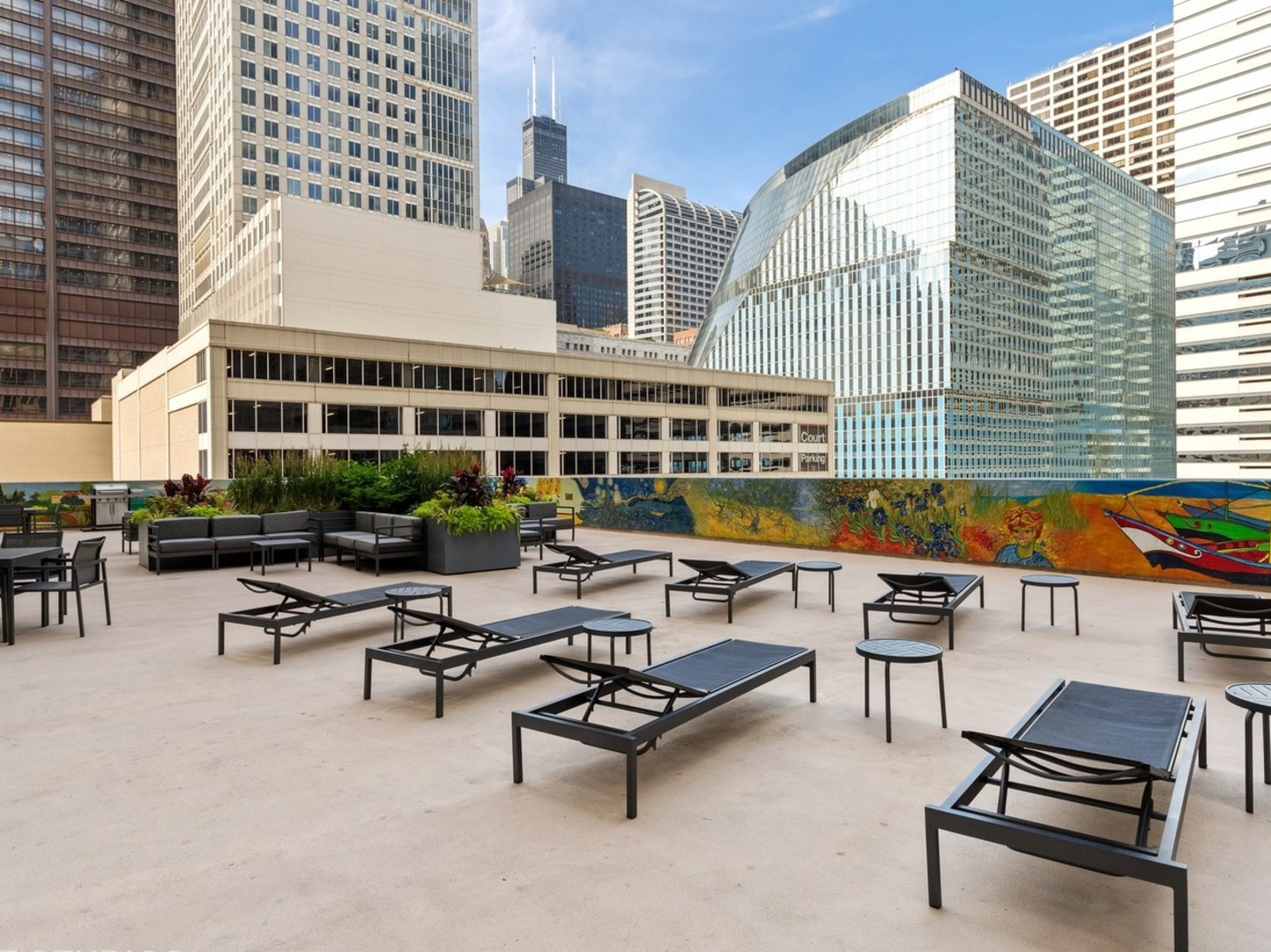 200 North Dearborn Street, Unit 1901 Chicago, IL 60601 - Photo 23 of 24 a roof deck with outdoor seating and city view