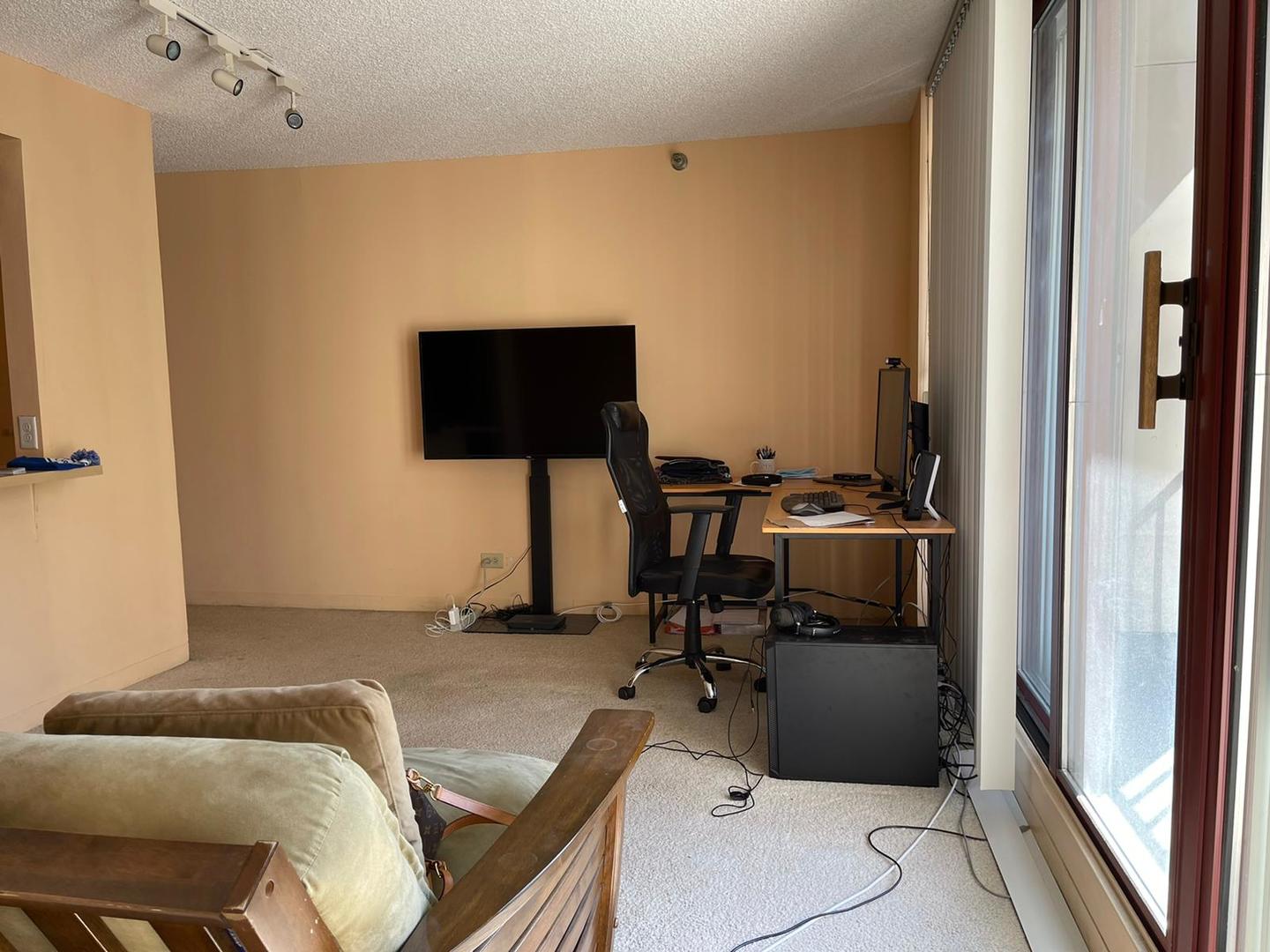 200 North Dearborn Street, Unit 1901 Chicago, IL 60601 - Photo 10 of 24 a room with furniture and a flat screen tv