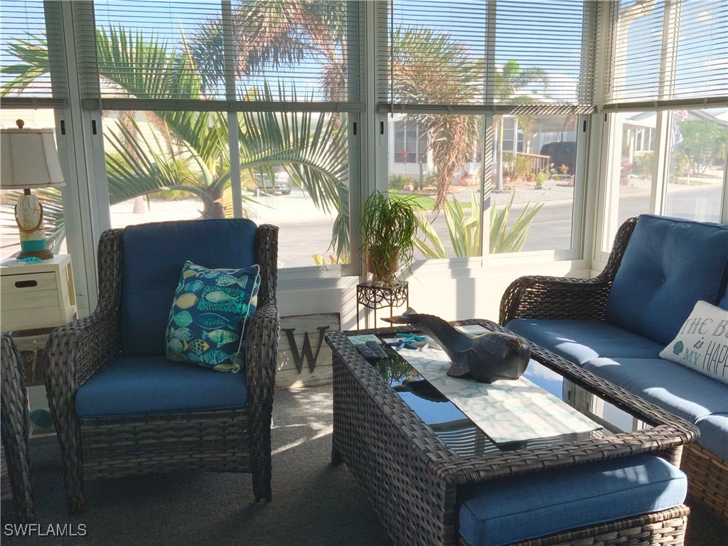 15550 Burnt Store Road, Unit 86 Punta Gorda, FL 33955 - Photo 15 of 36 a living room with furniture and a large window