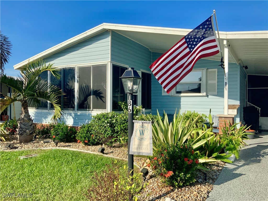 15550 Burnt Store Road, Unit 86 Punta Gorda, FL 33955 - Photo 2 of 36 a front view of a house with a yard