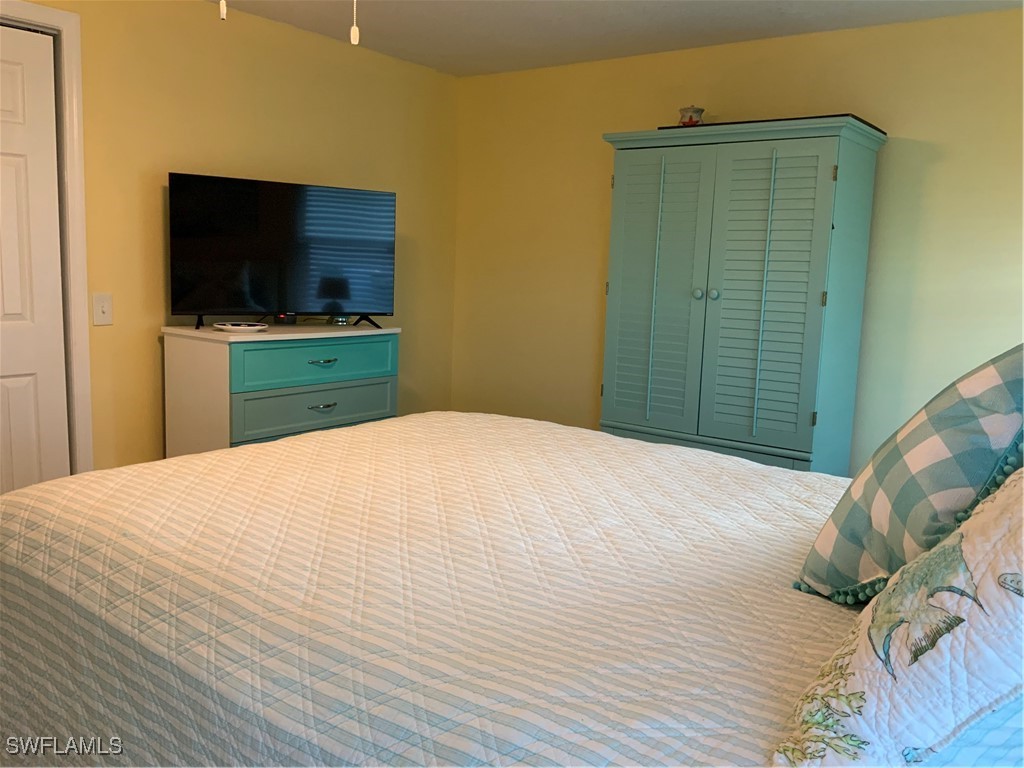 15550 Burnt Store Road, Unit 86 Punta Gorda, FL 33955 - Photo 21 of 36 a bedroom with a bed and a flat screen tv