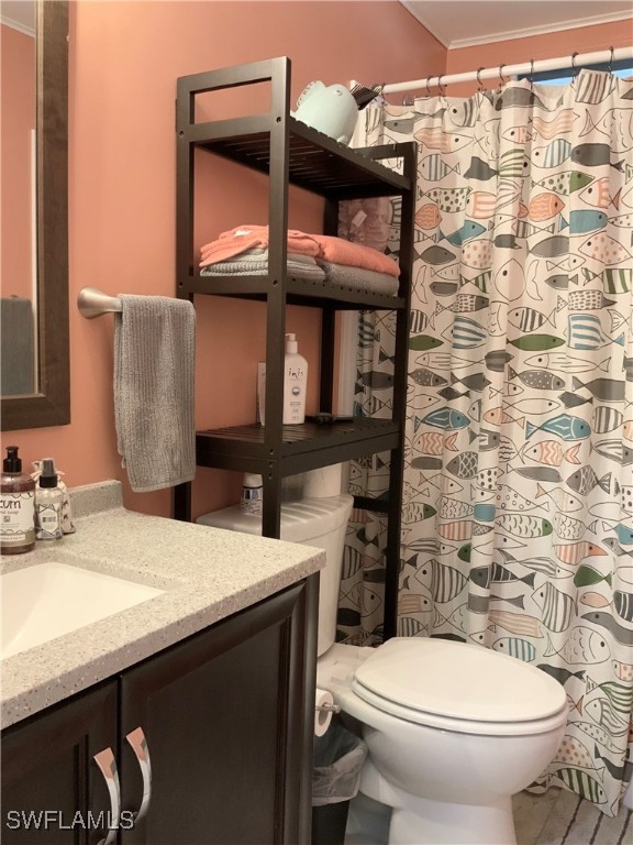 15550 Burnt Store Road, Unit 86 Punta Gorda, FL 33955 - Photo 22 of 36 a bathroom with a sink a toilet and a mirror