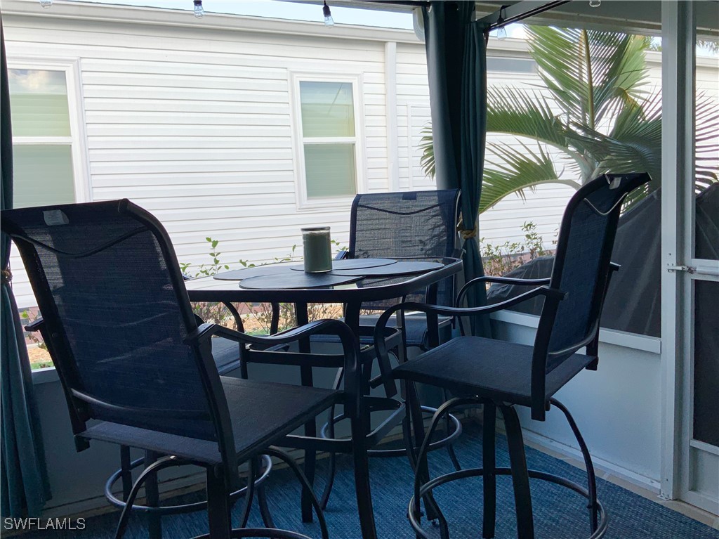 15550 Burnt Store Road, Unit 86 Punta Gorda, FL 33955 - Photo 7 of 36 a view of a dining room with furniture and window