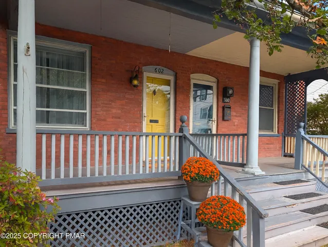 a view of a brick house with a large window