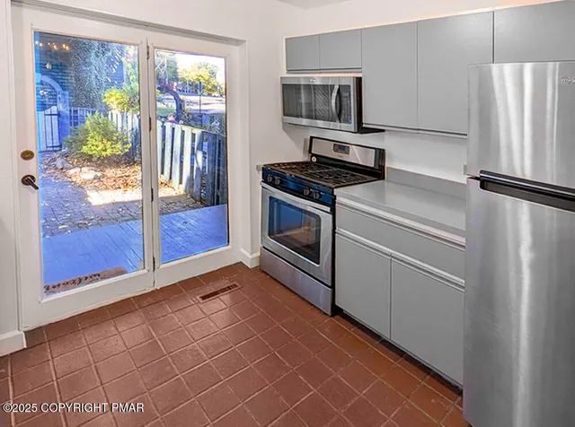 a kitchen with stainless steel appliances a refrigerator and a stove