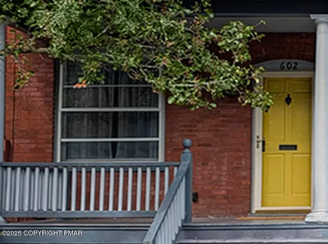 a backyard of a house with wooden floor and fence