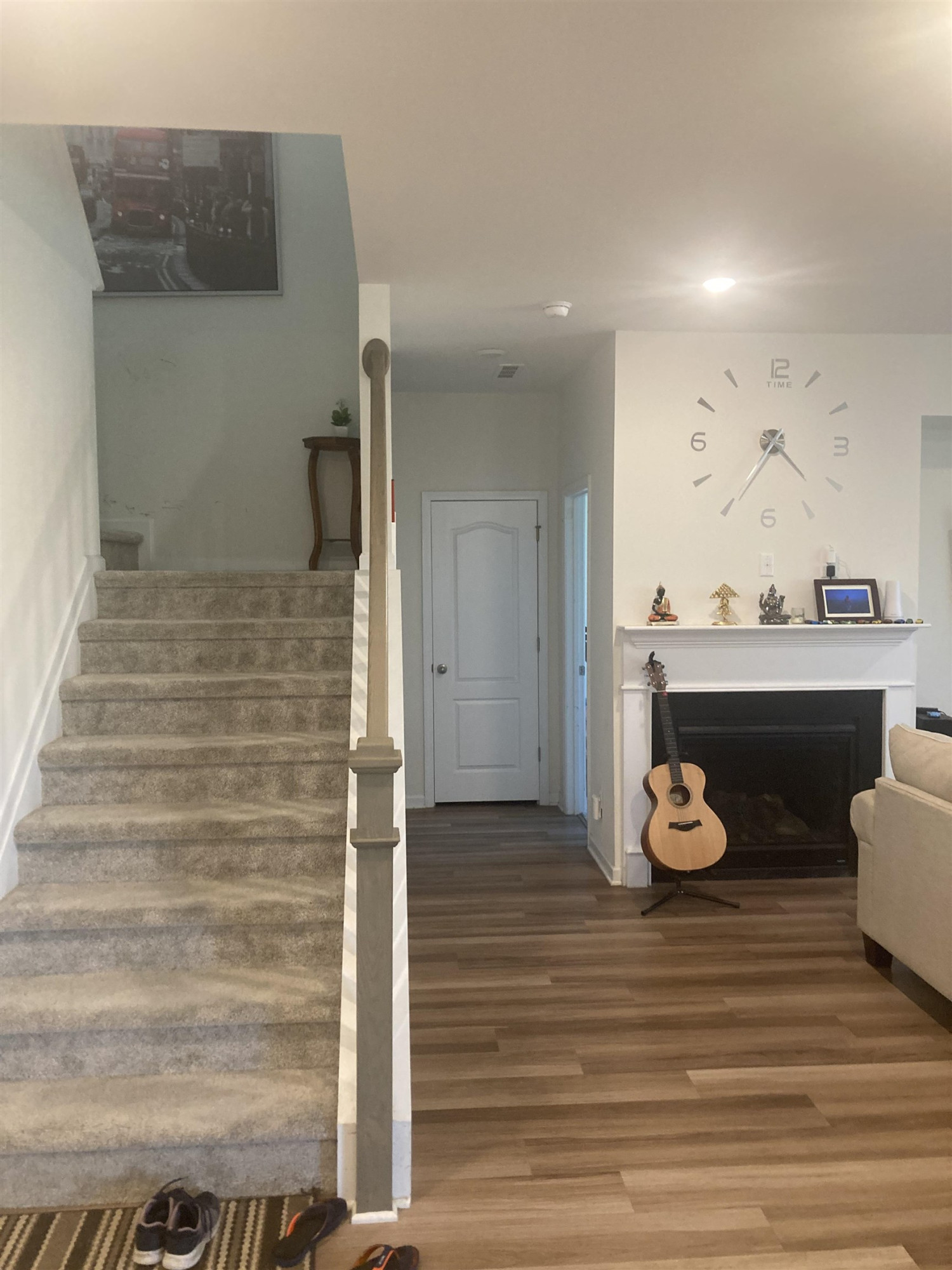 3514 Barn Road Apex, NC 27502 - Photo 17 of 53 a view of a hallway with wooden floor and a fireplace
