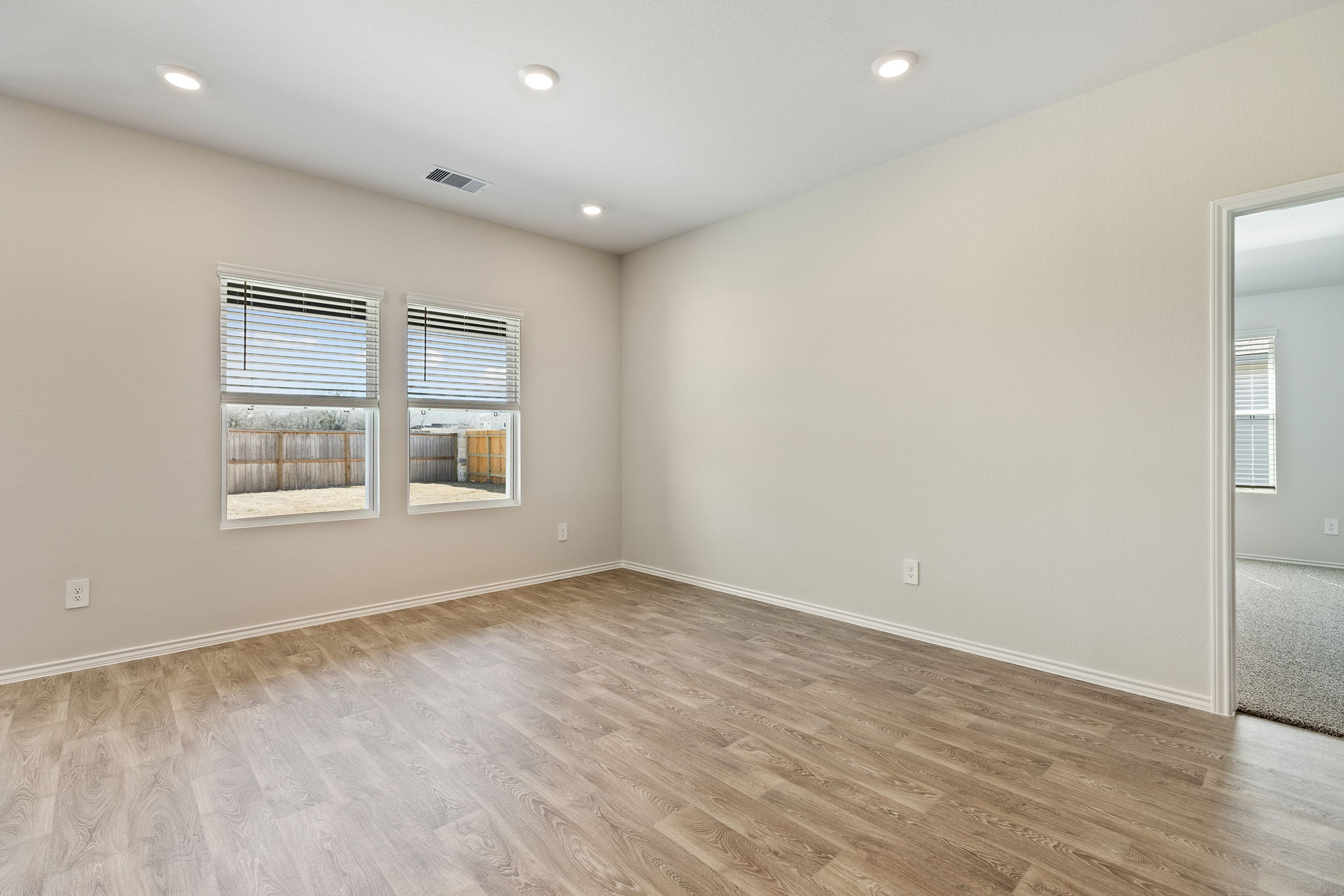 1702 Miller Terrace Lockhart, TX 78644 - Photo 15 of 21 an empty room with wooden floor and windows