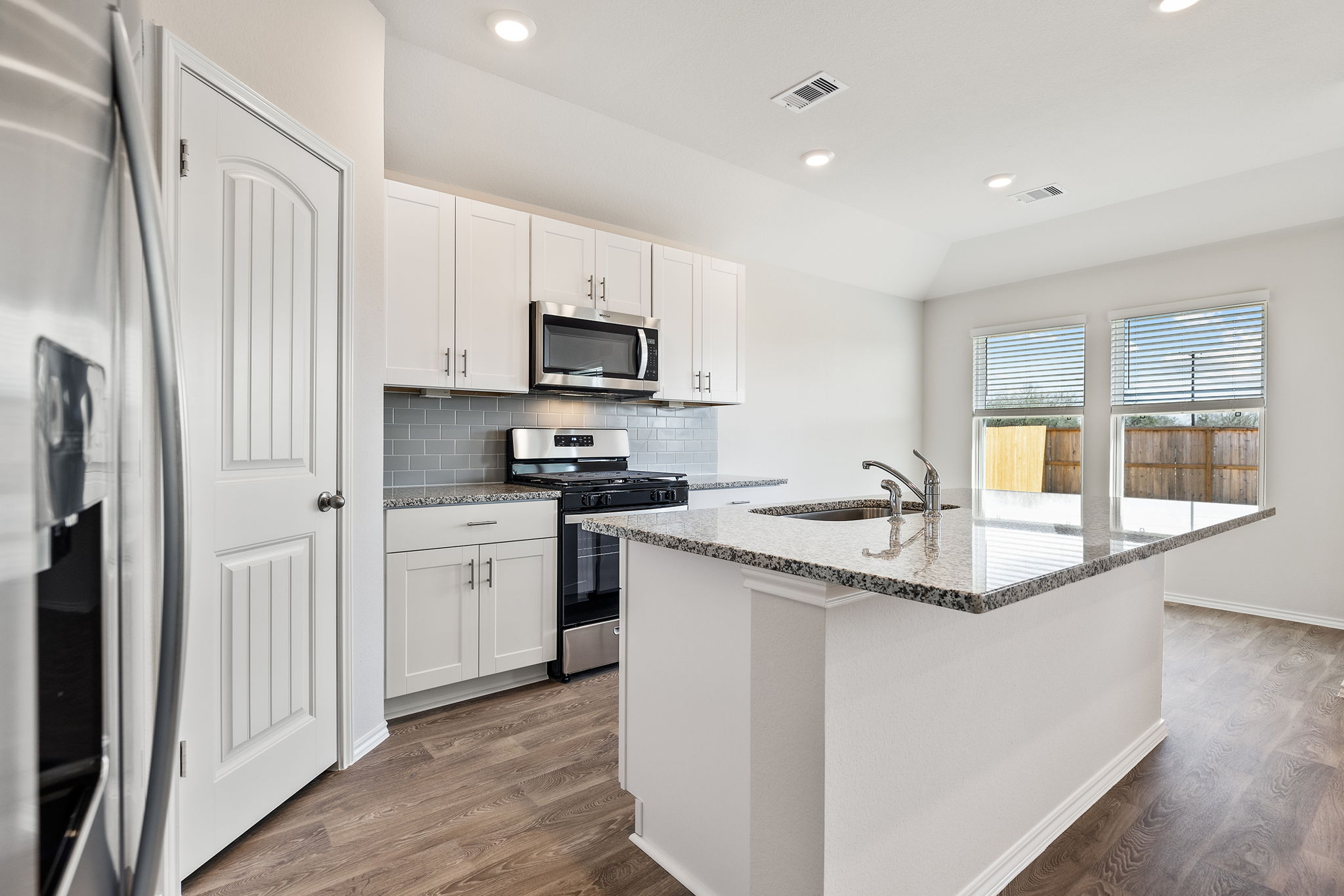1702 Miller Terrace Lockhart, TX 78644 - Photo 5 of 21 a kitchen with stainless steel appliances granite countertop a sink stove and refrigerator