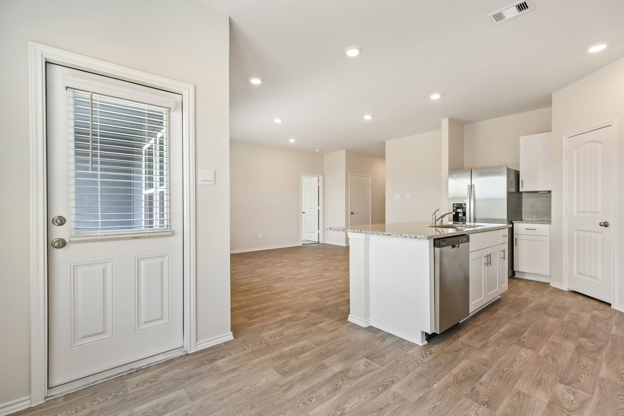 1702 Miller Terrace Lockhart, TX 78644 - Photo 7 of 21 a kitchen with a refrigerator and a stove top oven