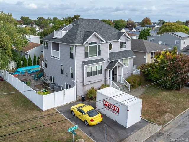a view of a house with a barbeque and chair