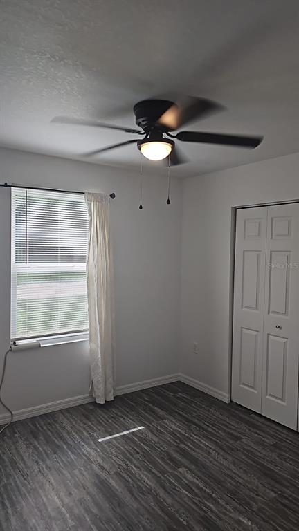 15028 Southwest 24th Place Ocala, FL 34481 - Photo 13 of 25 an empty room with wooden floor fan and windows