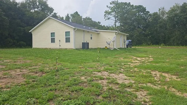 a view of a backyard with large trees