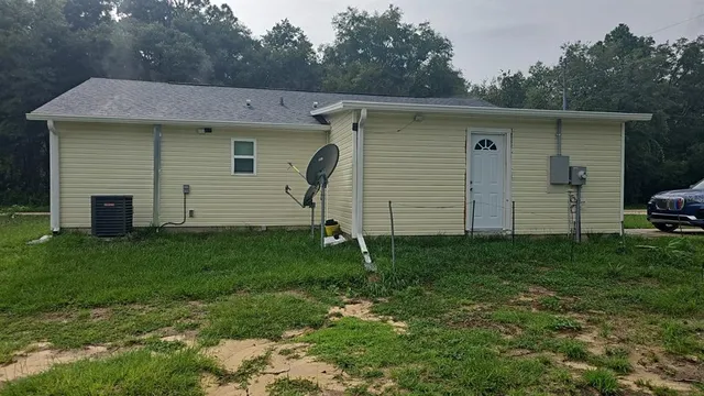 a view of a house with a backyard