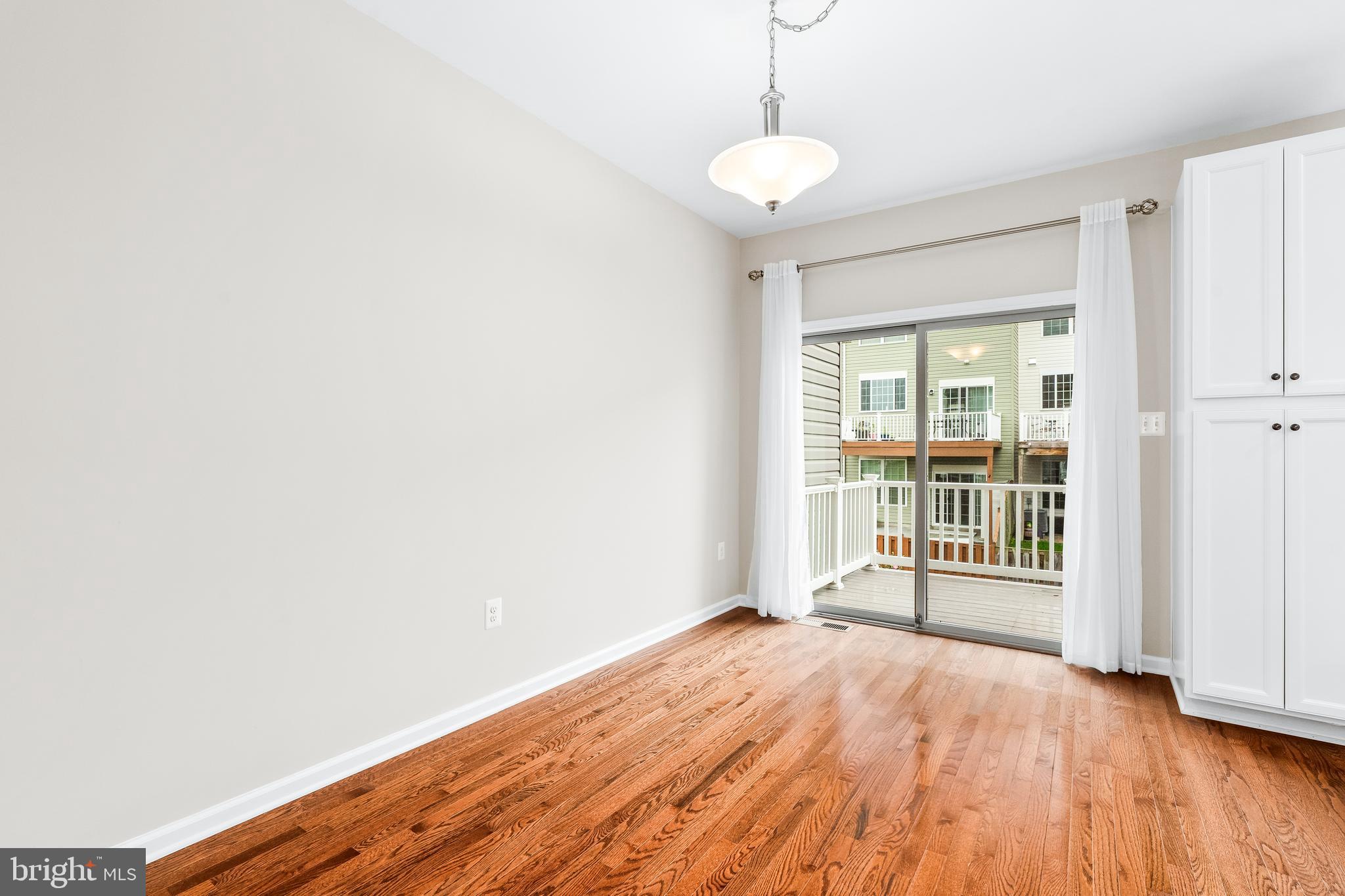 8479 Randell Ridge Road Frederick, MD 21704 - Photo 11 of 50 a view of empty room with wooden floor and fan
