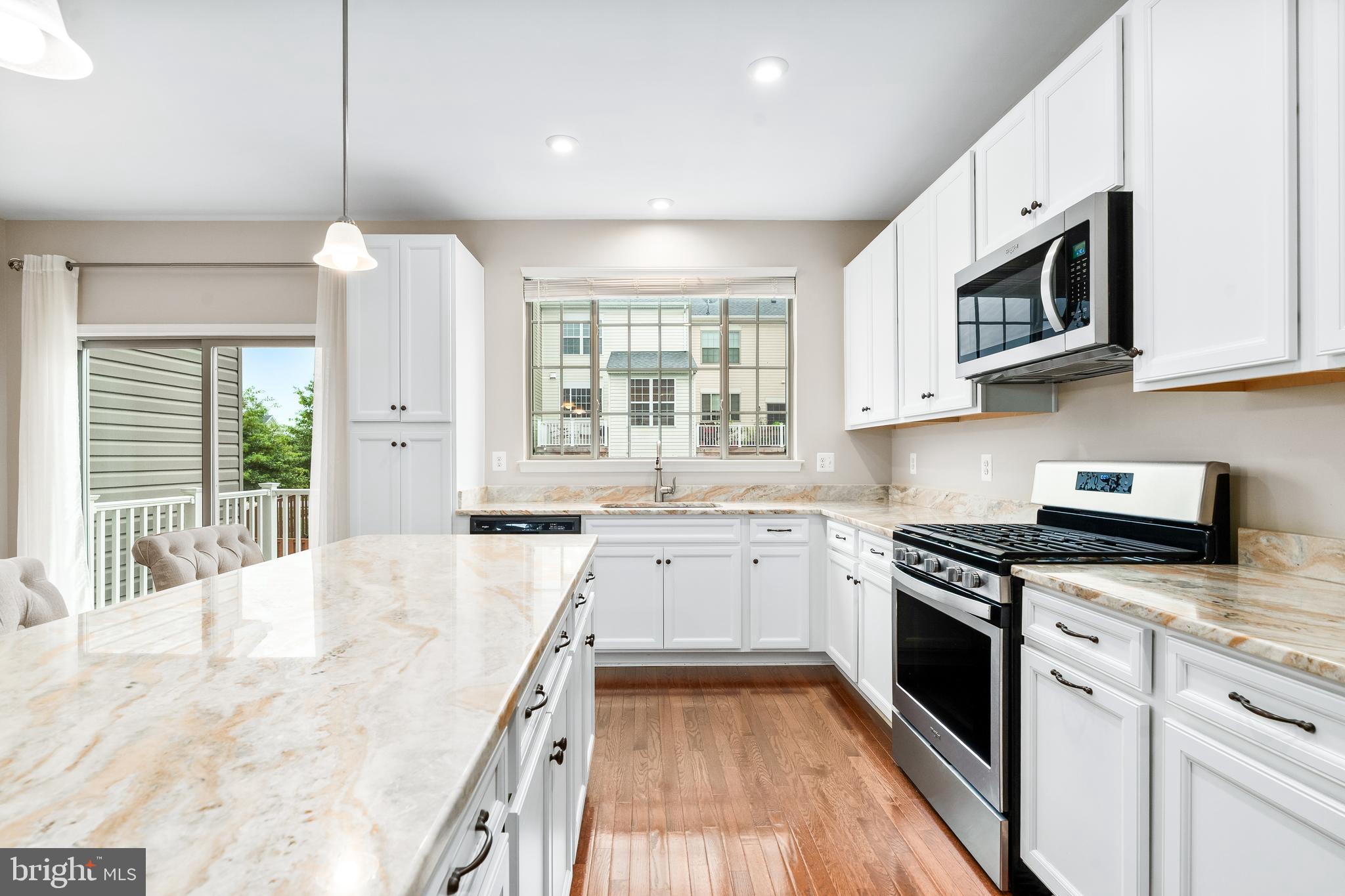 8479 Randell Ridge Road Frederick, MD 21704 - Photo 13 of 50 a large kitchen with stainless steel appliances granite countertop a stove a sink and a microwave