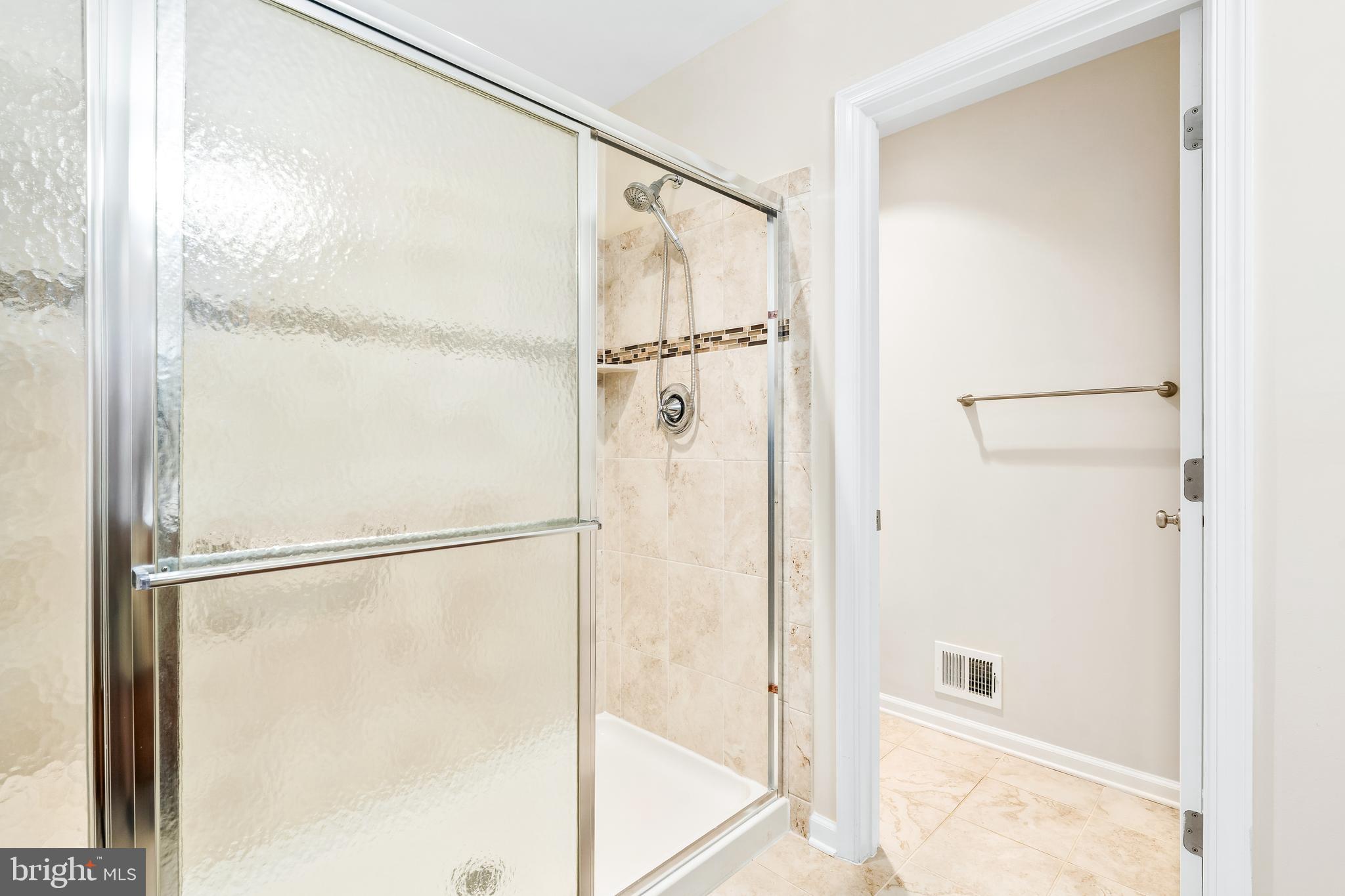 8479 Randell Ridge Road Frederick, MD 21704 - Photo 25 of 50 a bathroom with a glass shower door