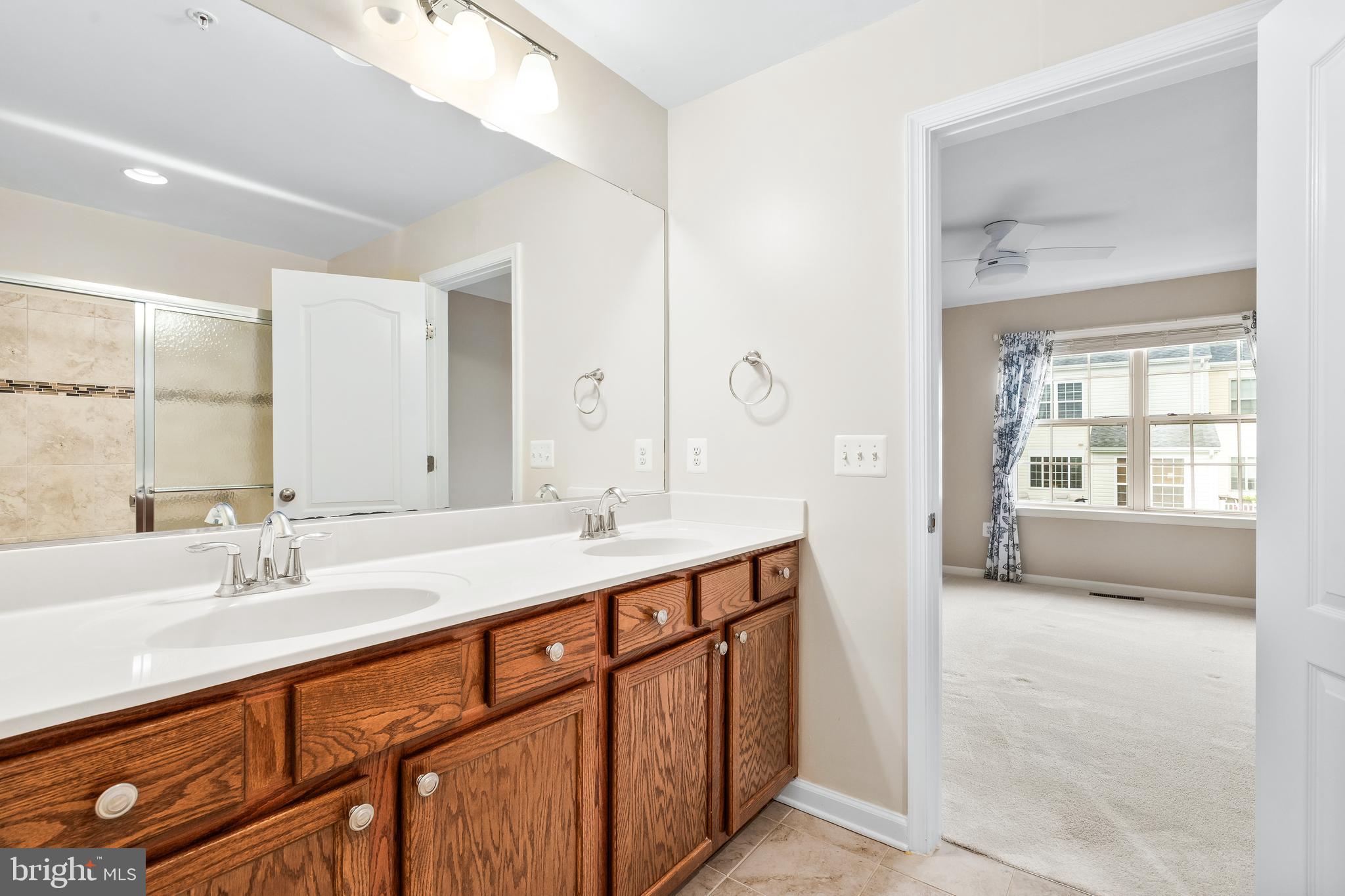8479 Randell Ridge Road Frederick, MD 21704 - Photo 26 of 50 a en suite bathroom with a double vanity sink and a mirror