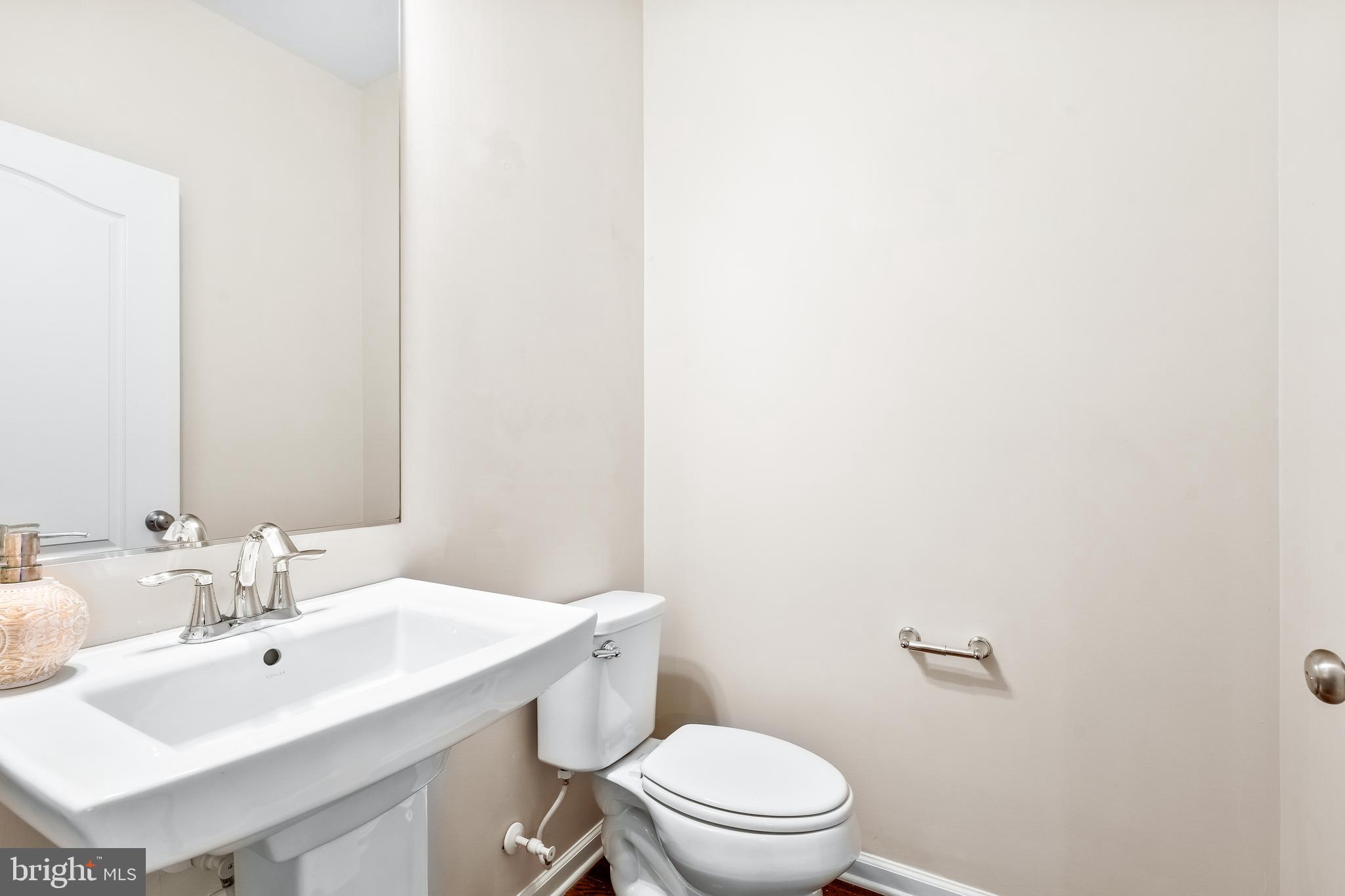 8479 Randell Ridge Road Frederick, MD 21704 - Photo 31 of 50 a bathroom with a toilet a sink and mirror